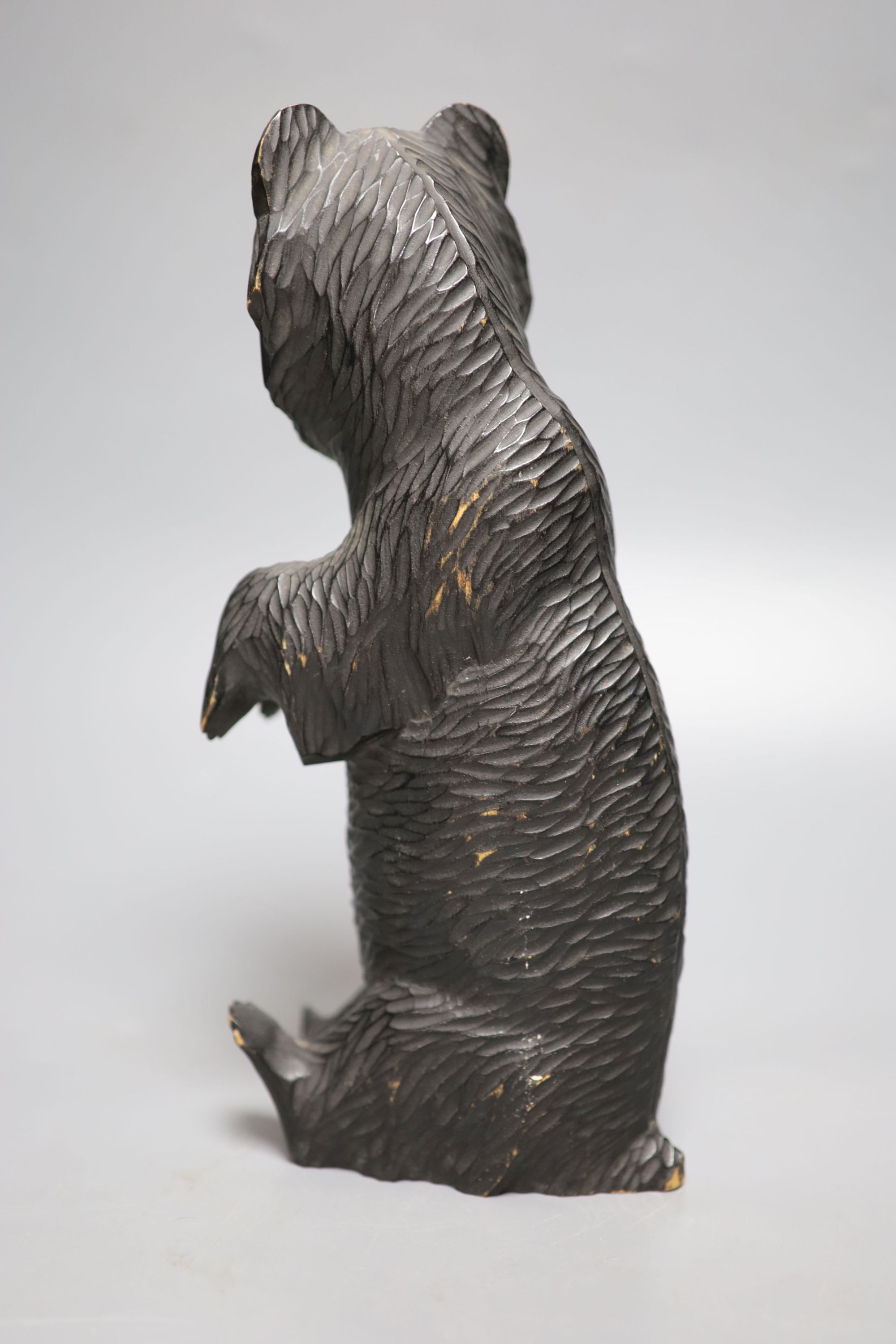 A Black Forest style carved bear, height 28cm